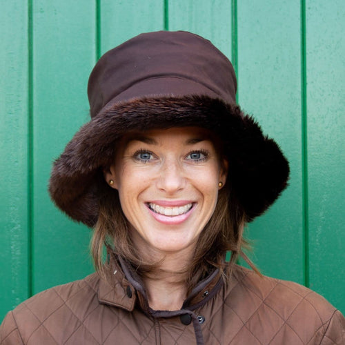 Olney Headwear Beth Ladies Brown Waxed Rain Hat With Faux Fur Trim And Fleece Lining On Woman